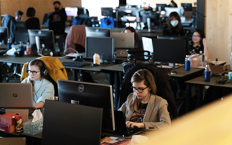 People working in an open office space. Photo.