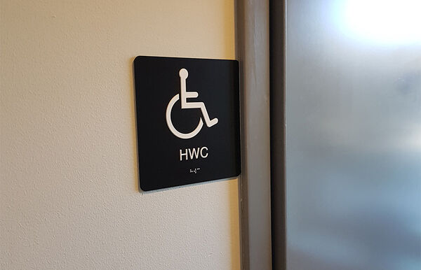 Sign for accessible bathroom. Photo.