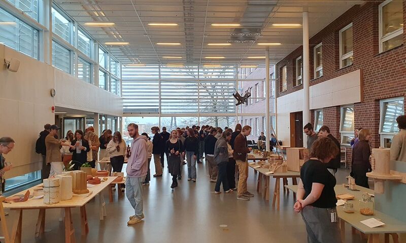 Photo of people looking at an exhibition in a large hall.