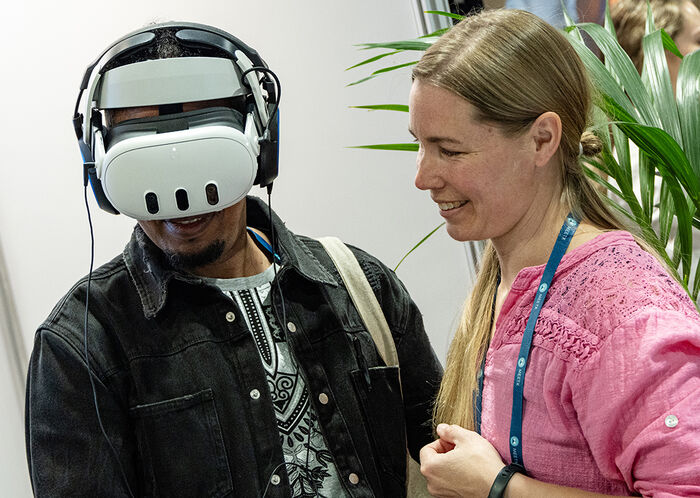  Två människor, den ena med VR-headset på. Foto.