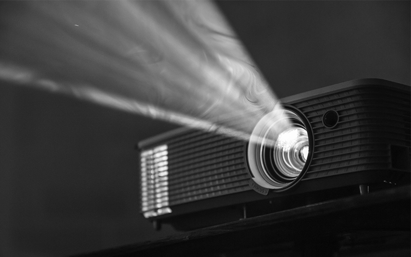 Close up of film projector lamp shining in the darkness.