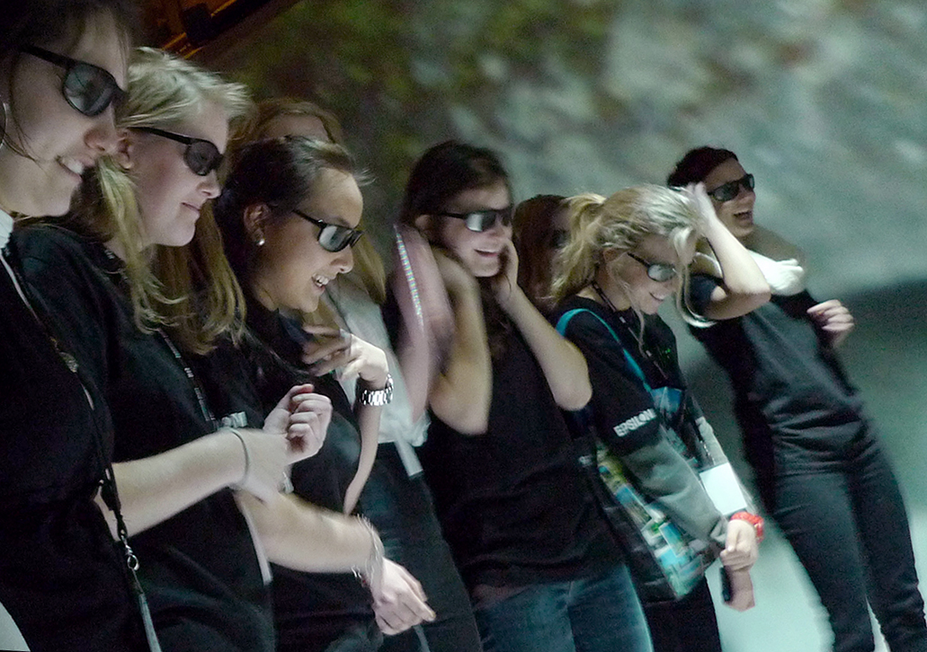 people in glasses reacting to a virtual environment. Photo. 